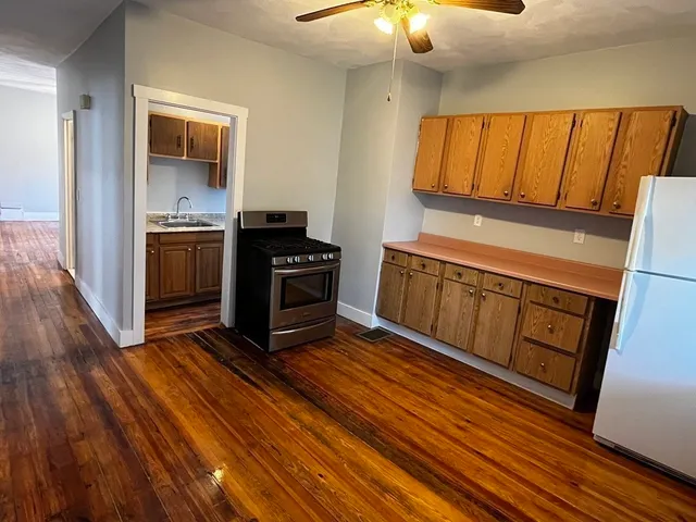 a kitchen with stainless steel appliances a stove and cabinets
