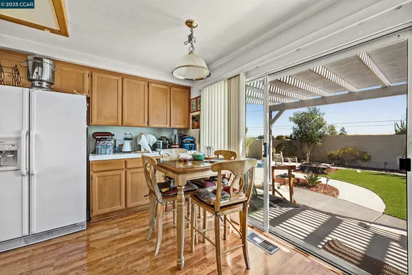a kitchen with a table chairs stove and refrigerator