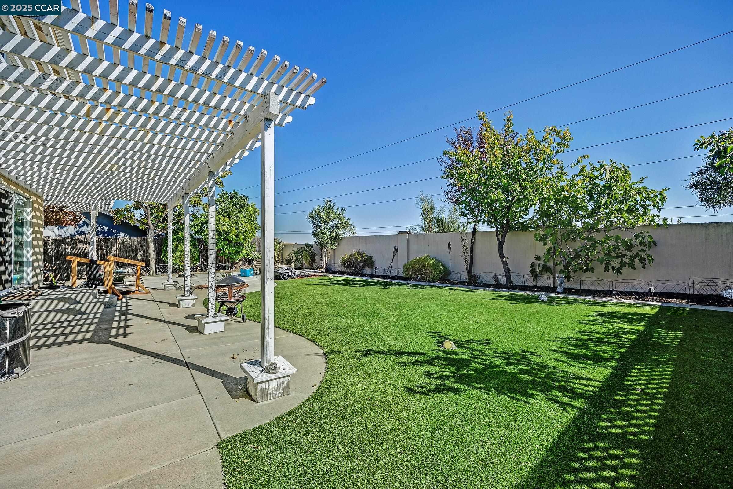 4653 Arabian Way Antioch, CA 94531 - Photo 2 of 13 a view of a backyard with couches plants and large tree