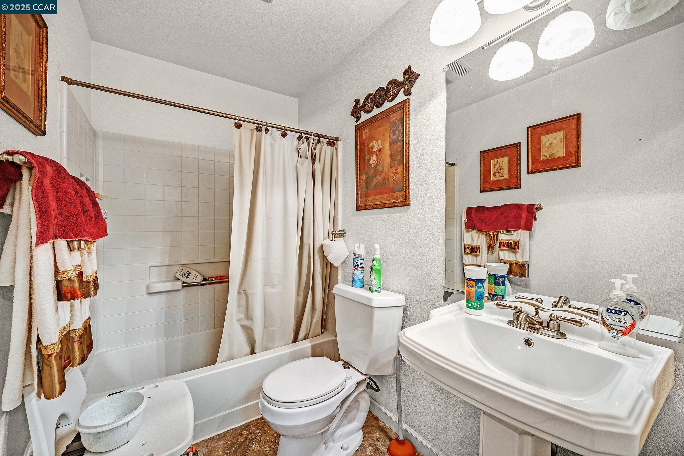 4653 Arabian Way Antioch, CA 94531 - Photo 8 of 13 a bathroom with a sink toilet and shower