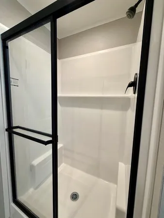 a bathroom with a glass shower door