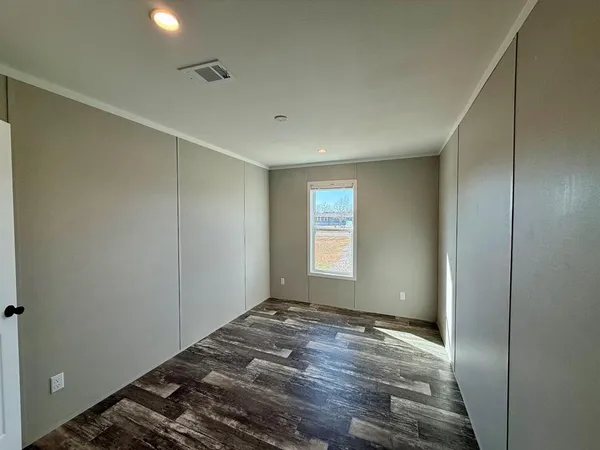 a view of a room with wooden floor and window