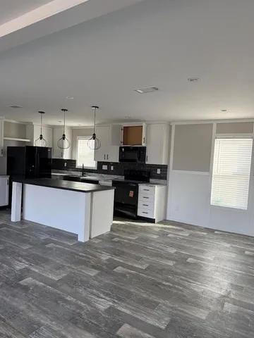 a kitchen with granite countertop a stove and a sink