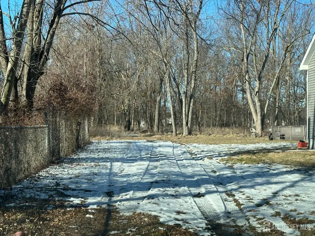 a backyard of a house with trees and outdoor
