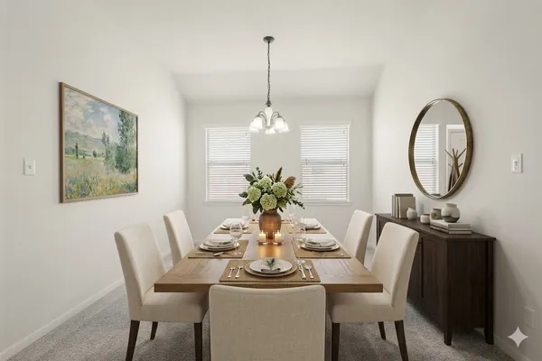 a dining room with furniture a potted plant and a chandelier
