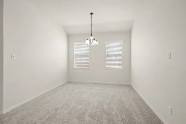 a view of a room with windows and a chandelier