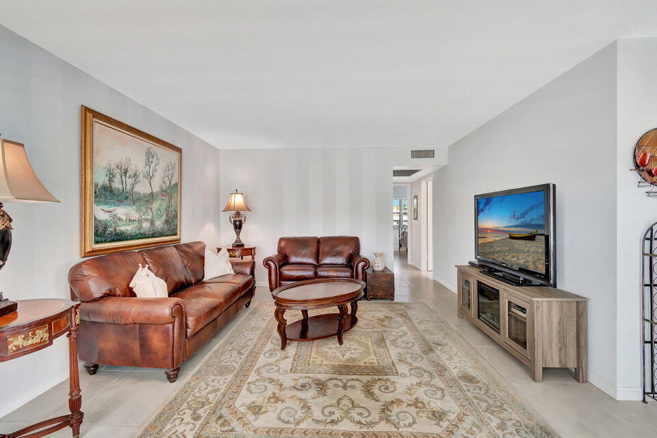 150 Dorset D, Unit 150 Boca Raton, FL 33434 - Photo 13 of 82 a living room with furniture and a flat screen tv