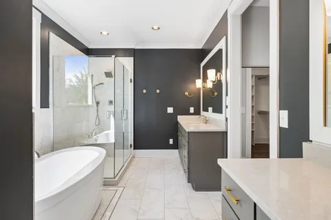 a bathroom with a bathtub shower sink and toilet