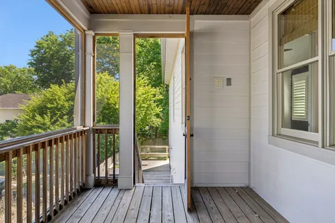 a view of a balcony with wooden floor