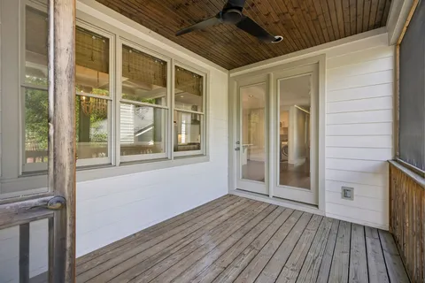 a view of a porch with wooden floor and a window