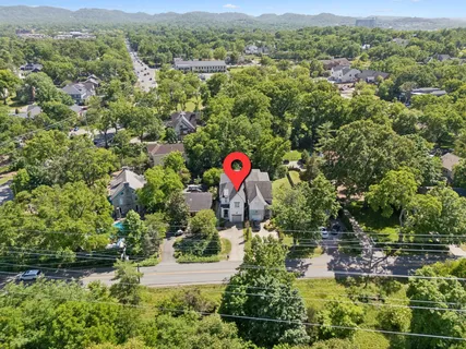 an aerial view of a house with a yard and lake view