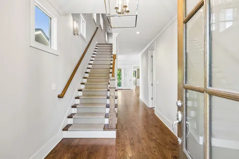 a view of entryway and hall with wooden floor
