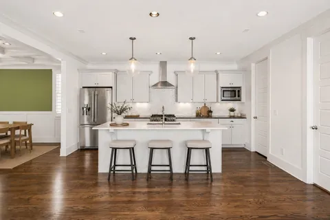 a kitchen with white cabinets and stainless steel appliances