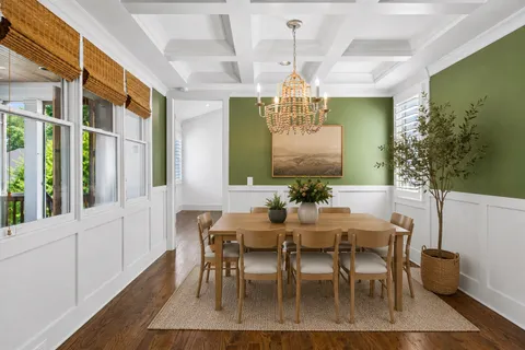 a view of a dining room with furniture and chandelier