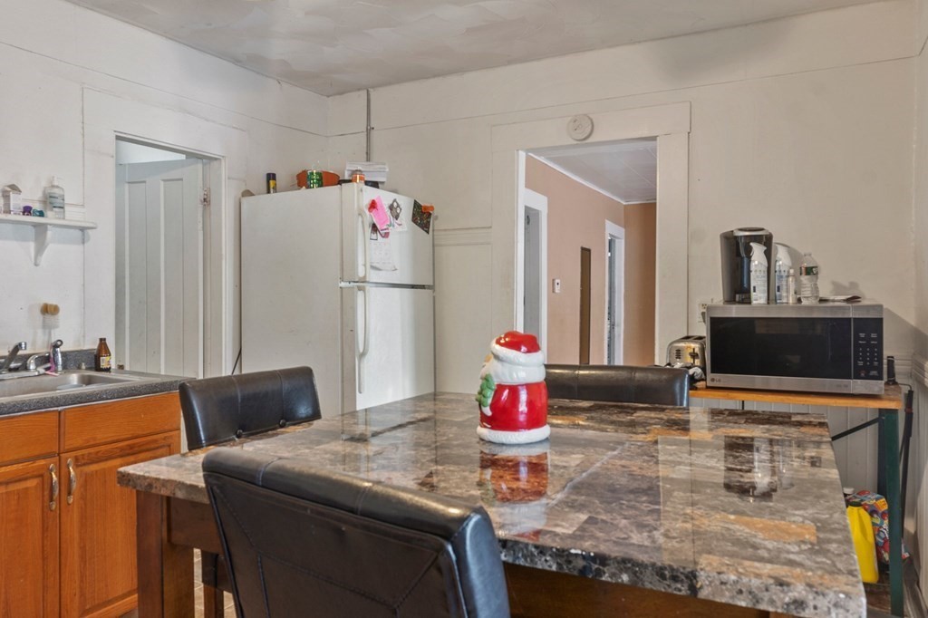 130 Myrtle Street Springfield, MA 01151 - Photo 2 of 25 a kitchen with stainless steel appliances granite countertop a sink refrigerator and microwave