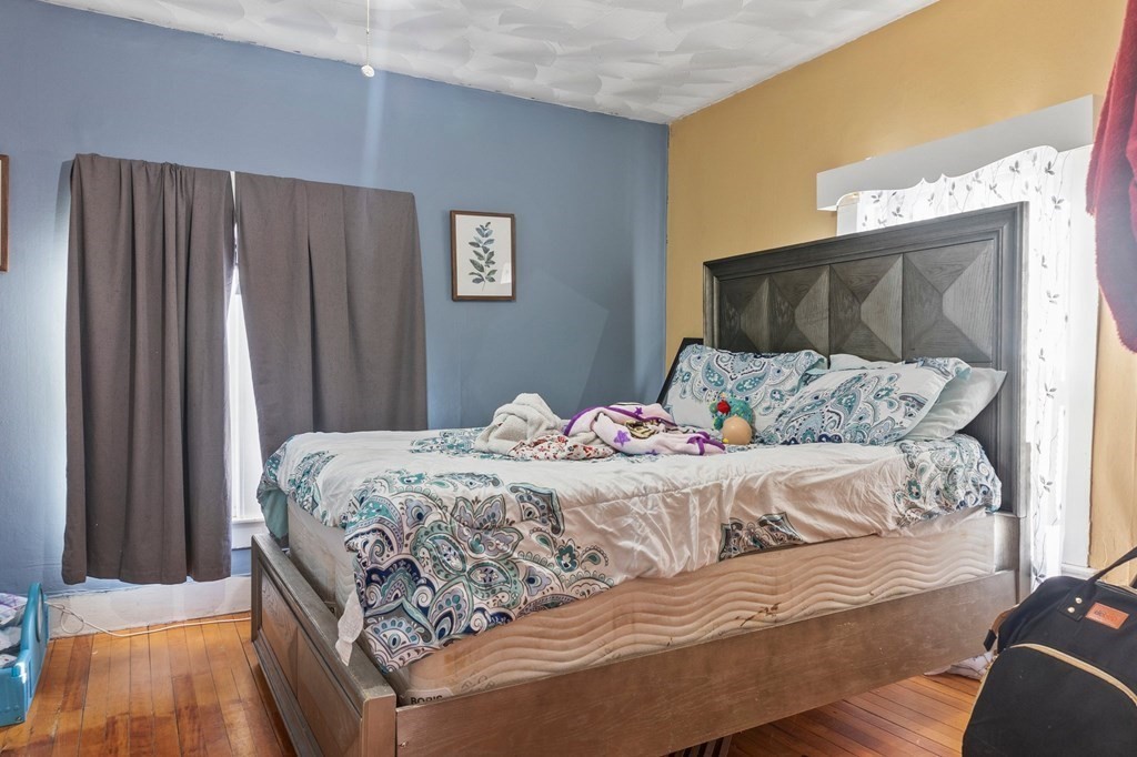 130 Myrtle Street Springfield, MA 01151 - Photo 10 of 25 a bedroom with a bed and a cabinets