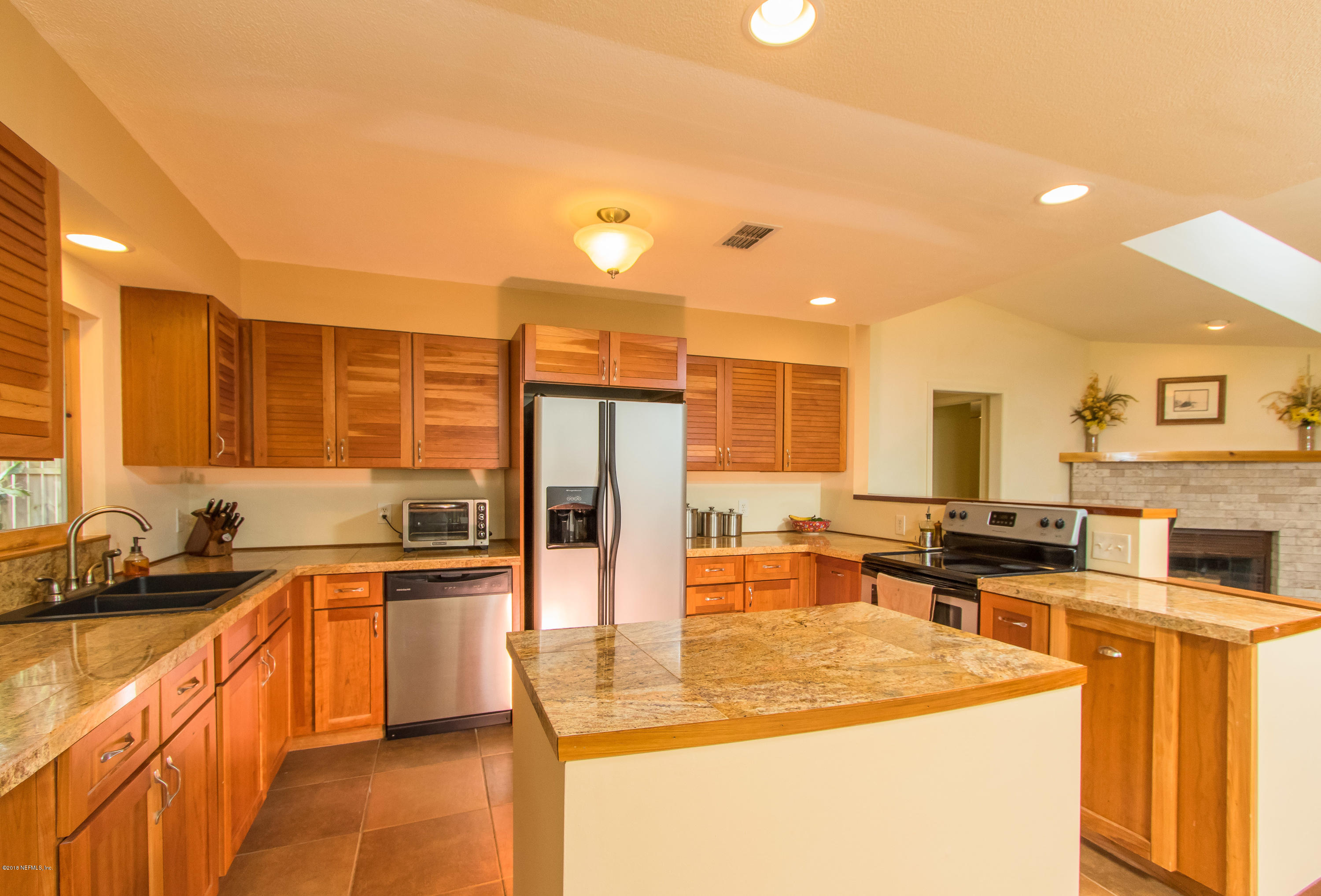 140 Nautilus Road St. Augustine, FL 32086 - Photo 8 of 42 a kitchen with stainless steel appliances granite countertop a sink and cabinets