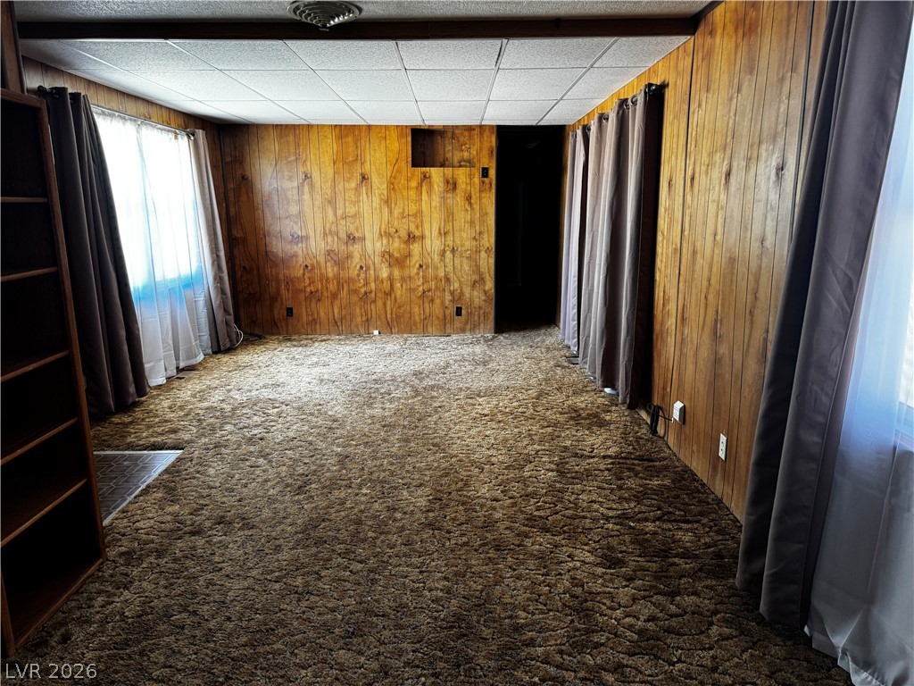 3090 Gally Road Pahrump, NV 89060 - Photo 11 of 20 A versatile room featuring classic wood paneling and plush carpeting, offering a cozy retreat.