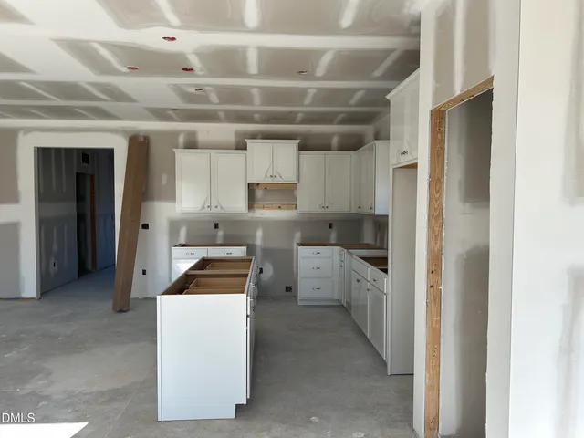a kitchen that has a lot of cabinets in it and stainless steel appliances
