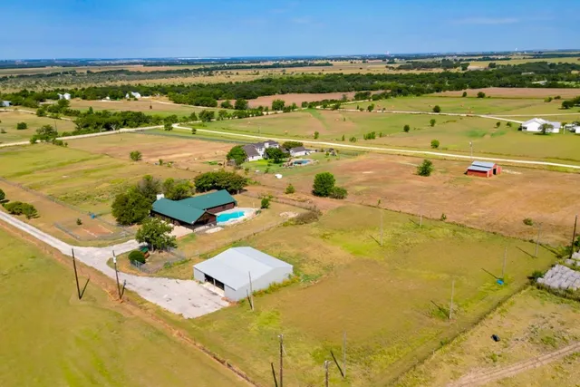 a kitchen with granite countertop wooden cabinets and stainless steel appliances