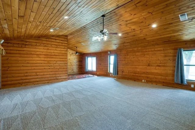 a view of an empty room with a ceiling fan