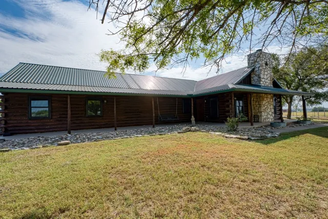 a view of a swimming pool with an outdoor seating area and barbeque oven