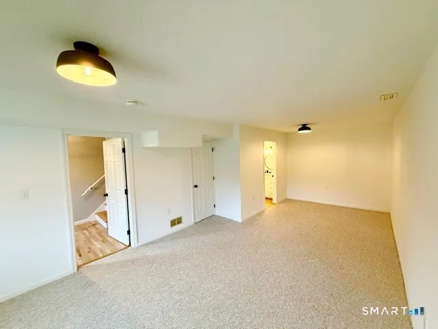 an empty room with windows and closet