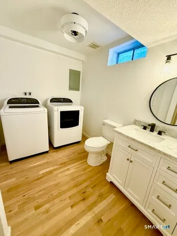 a bathroom with a sink a toilet and a mirror