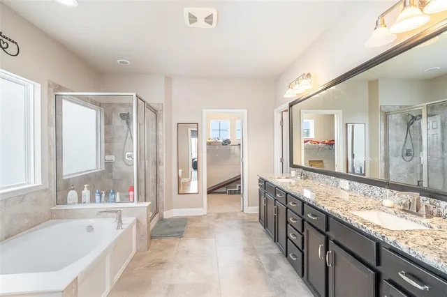 a bathroom with granite countertop a sink and a mirror