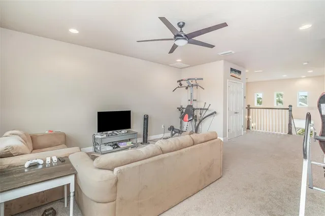 a view of a workspace with furniture and a flat screen tv