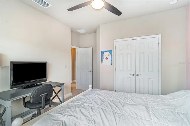 a bedroom with a bed and a desk