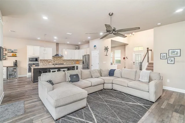 a living room with furniture and kitchen view