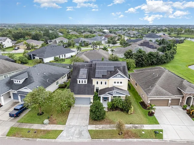 an aerial view of a house with a yard