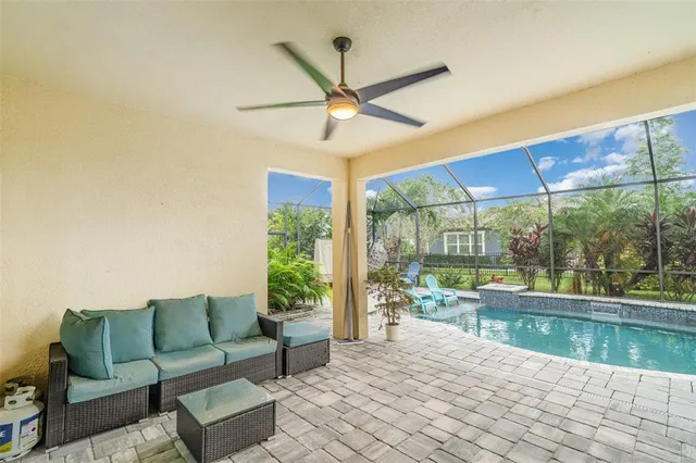a swimming pool with barbeque in glass door and glass windows
