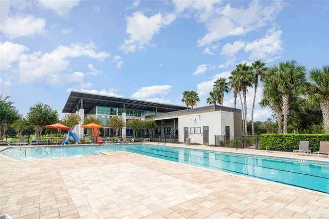 swimming pool view with a garden space