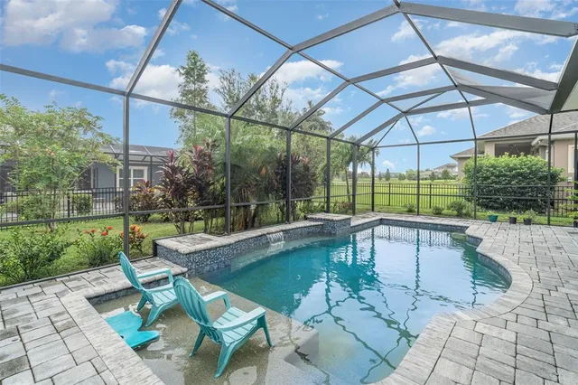 a view of a house with a chairs and table in a yard