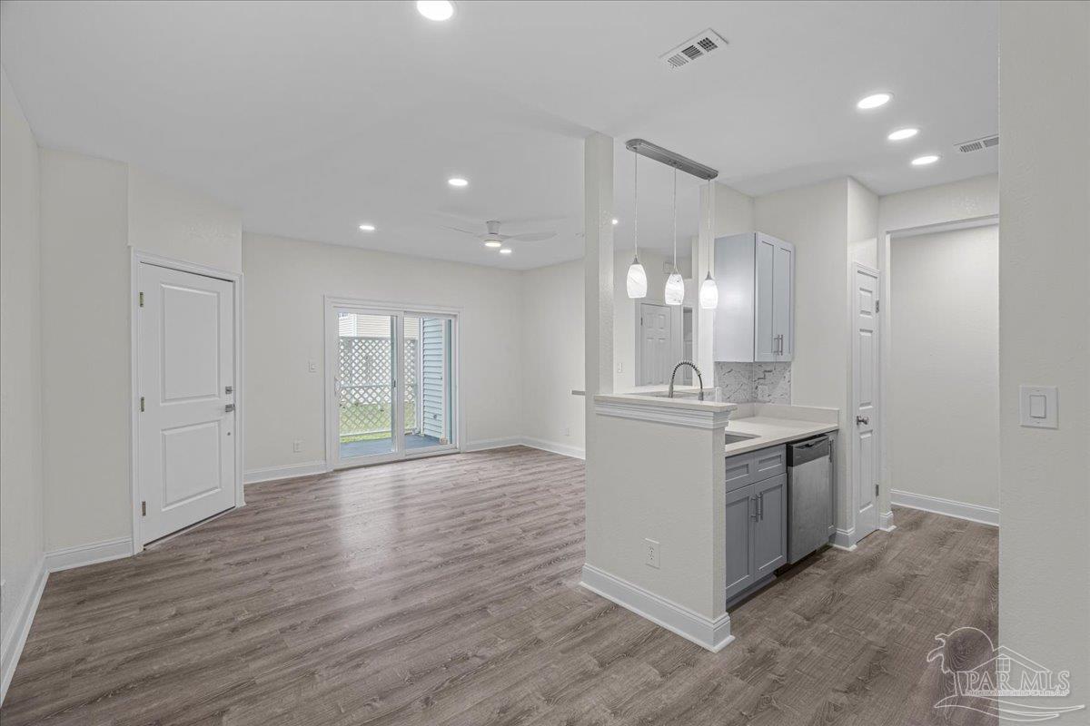 601 East Burgess Road, Unit C3 Pensacola, FL 32504 - Photo 12 of 35 a large kitchen with a sink and dishwasher a stove with wooden floors