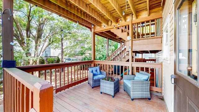 a view of balcony with wooden floor and outdoor seating