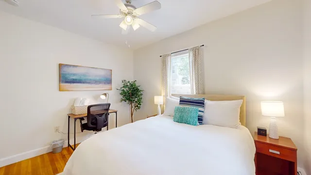 a bedroom with a large bed and a chandelier