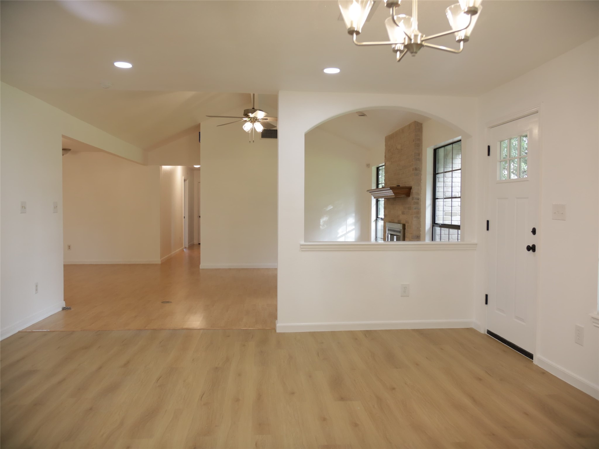1612 Buttercup Road Pflugerville, TX 78660 - Photo 6 of 16 A well-lit interior showcases smooth wooden flooring and an elegant chandelier illuminating the space.