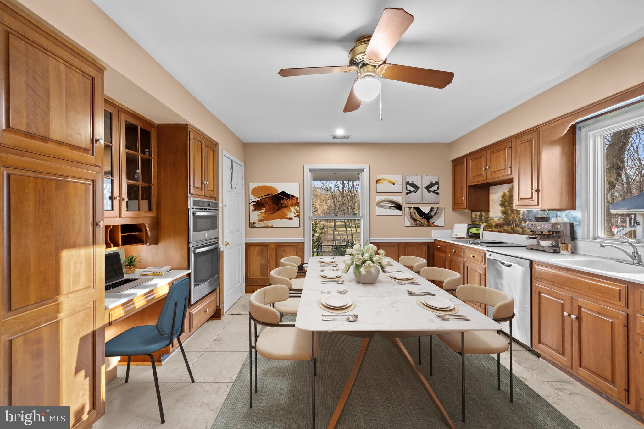 10622 Old Colchester Road Lorton, VA 22079 - Photo 20 of 23 a kitchen with stainless steel appliances kitchen island granite countertop a table chairs and a refrigerator