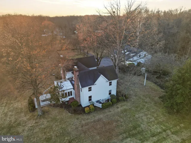 a view of a swimming pool with lawn chairs and tables