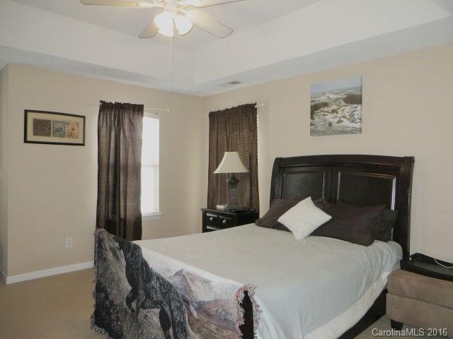 13412 Michael Lynn Road Charlotte, NC 28278 - Photo 11 of 16 a bedroom with a bed and a chandelier