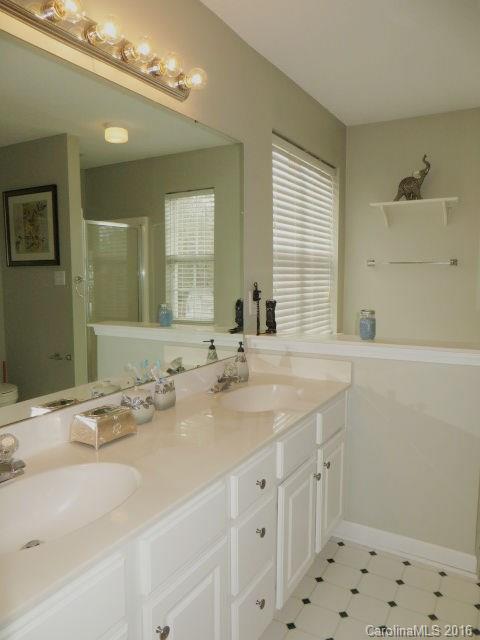 13412 Michael Lynn Road Charlotte, NC 28278 - Photo 12 of 16 a bathroom with double sink and a mirror