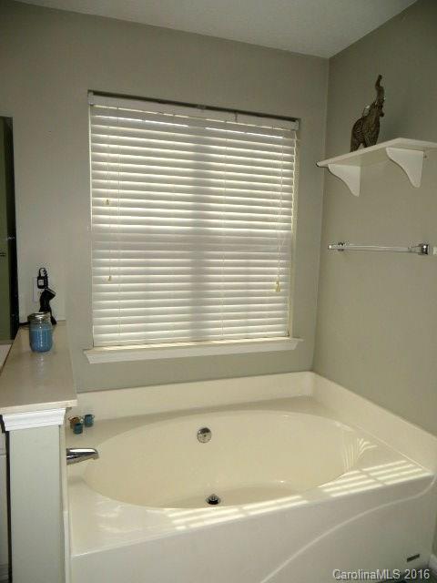 13412 Michael Lynn Road Charlotte, NC 28278 - Photo 13 of 16 a white bath tub sitting next to a window