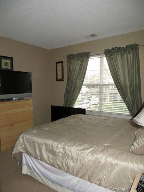 13412 Michael Lynn Road Charlotte, NC 28278 - Photo 14 of 16 a bed sitting in a bedroom next to a window