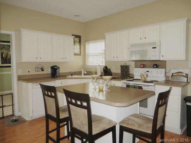 13412 Michael Lynn Road Charlotte, NC 28278 - Photo 10 of 16 a kitchen with a dining table and chairs