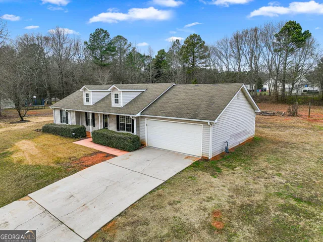 a aerial view of a house next to a yard
