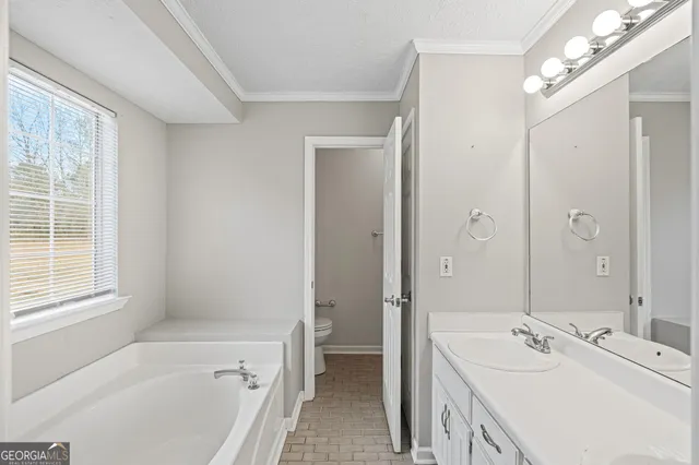 a white bath tub sitting next to a white sink