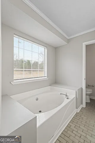 a bathroom with a double vanity sink mirror and toilet